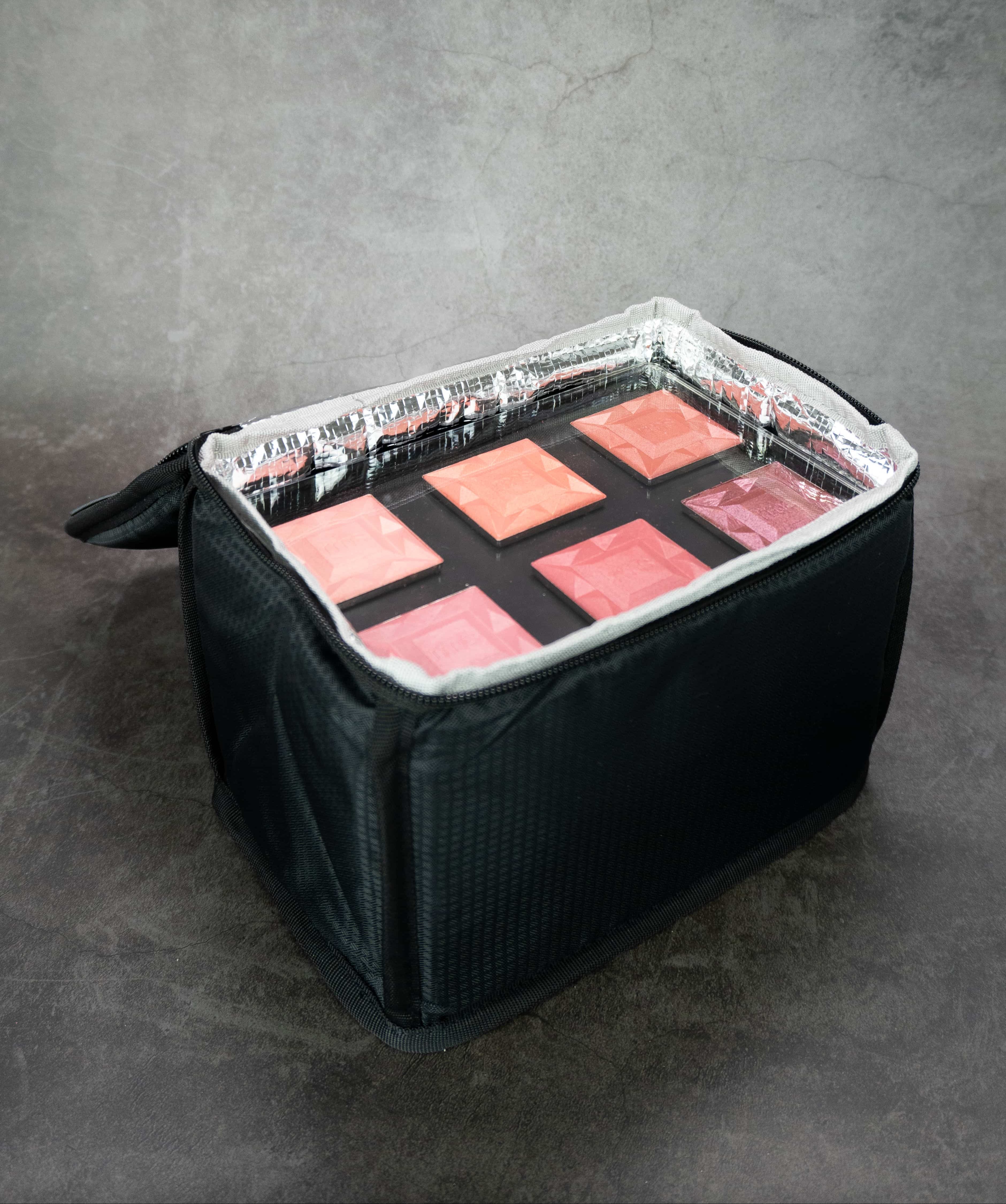 Makeup bag filled with makeup palettes.